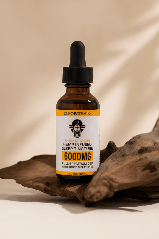 Cleopatra Hemp Infused 6000mg full-spectrum CBD sleep tincture with melatonin in amber dropper bottle on wooden surface